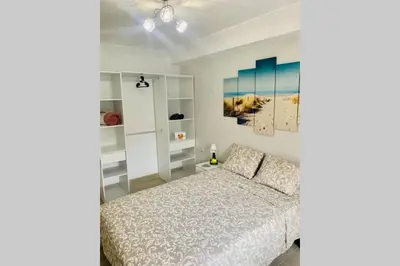 a bedroom with a bed and a painting on the wall at VALENCIA / PLAYA CABANYAL, PUERTO, CUIDAD ARTES in Valencia