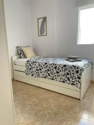 a bedroom with a bed in a room at UIM Mediterraneo ATICO Poeta 7 Wifi in Puerto de Sagunto