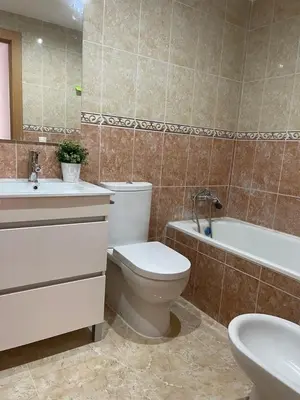 a bathroom with a toilet and a tub and a sink at UIM Mediterraneo ATICO Poeta 7 Wifi in Puerto de Sagunto