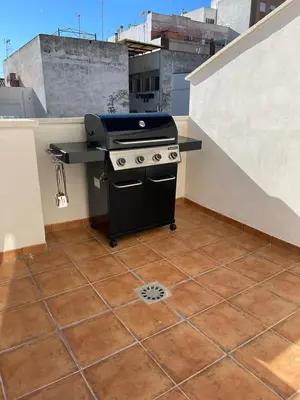 a grill on the roof of a rooftop at UIM Mediterraneo ATICO Poeta 7 Wifi in Puerto de Sagunto