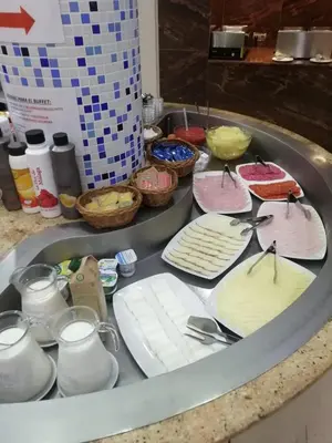 a sink filled with different types of cakes at Hotel Vent de Mar in Puerto de Sagunto