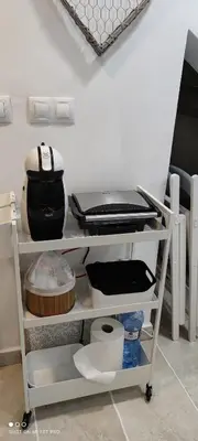 a kitchen with a shelf with dishes and pans at El Enclave in Chulilla