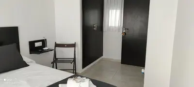 a bedroom with a bed and a chair and a door at El Enclave in Chulilla