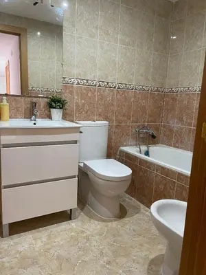 a bathroom with a toilet and a sink and a tub at UIM Mediterraneo ATICO Poeta 8 Wifi in Puerto de Sagunto