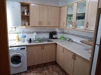 a kitchen with a sink and a washing machine at FLAMING 2 in Cullera