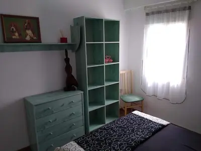 a bedroom with a green dresser and a green cabinet at FLAMING 2 in Cullera