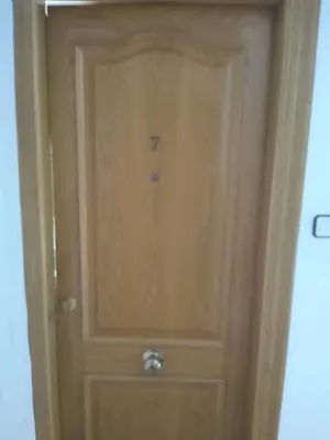 a wooden door with the number seven on it at FLAMING 2 in Cullera