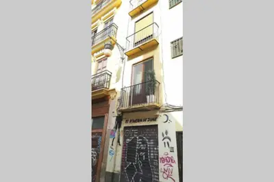 a building with a sign on the side of it at Precioso Apartamento frente del Mercado Central in Valencia