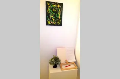 a table with a plant and a picture on the wall at Precioso Apartamento frente del Mercado Central in Valencia