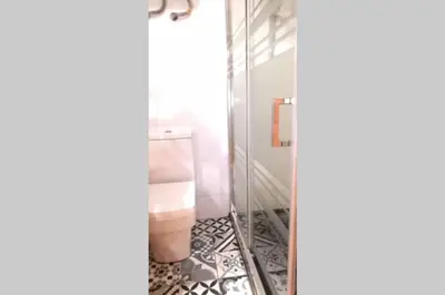 a bathroom with a toilet and a glass shower at Precioso Apartamento frente del Mercado Central in Valencia