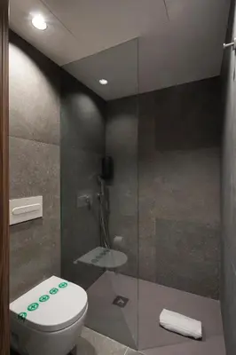 a bathroom with a toilet and a glass shower at Dau Studios in Valencia