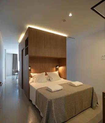 a bedroom with a large bed with two towels on it at Dau Studios in Valencia