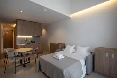 a hotel room with a bed and a table with chairs at Dau Studios in Valencia