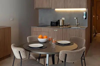a kitchen with a table with a bowl of oranges on it at Dau Studios in Valencia
