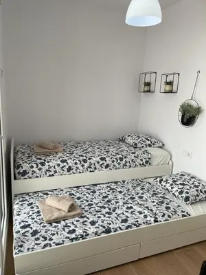 two beds sitting next to each other in a room at UIM Mediterraneo Poeta 6 Wifi in Puerto de Sagunto