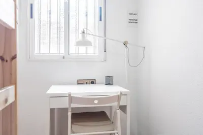 a white desk with a lamp and a chair at Maritim Horizon House Port of Valencia in Valencia