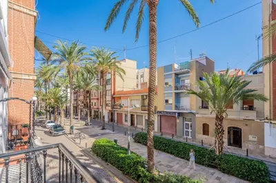 a city street with palm trees and buildings at Maritim Horizon House Port of Valencia in Valencia