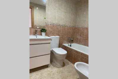 a bathroom with a toilet and a sink and a tub at UIM Mediterraneo Poeta 2 Wifi in Puerto de Sagunto