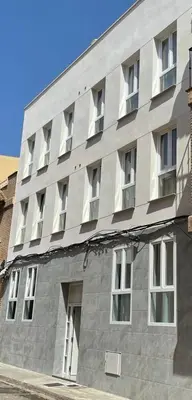 a large gray building with windows on the side of it at UIM Mediterraneo Poeta 2 Wifi in Puerto de Sagunto