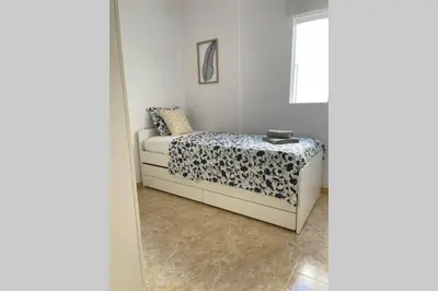 a bedroom with a bed and a window at UIM Mediterraneo Poeta 2 Wifi in Puerto de Sagunto