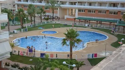 a large swimming pool in a building with people in it at Nova Almenara. Ideal para familias in Barrio-Mar