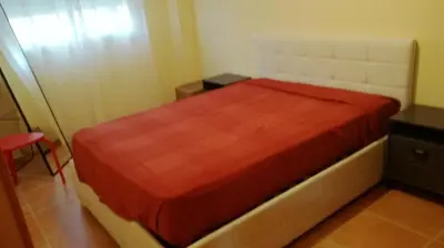 a bedroom with a bed with a red blanket at Nova Almenara. Ideal para familias in Barrio-Mar