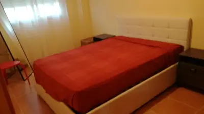 a bedroom with a bed with a red blanket at Nova Almenara. Ideal para familias in Barrio-Mar
