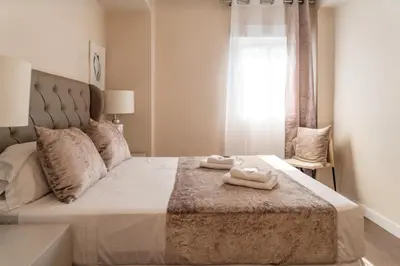 a bedroom with a bed with two towels on it at MD Galán Street in Valencia