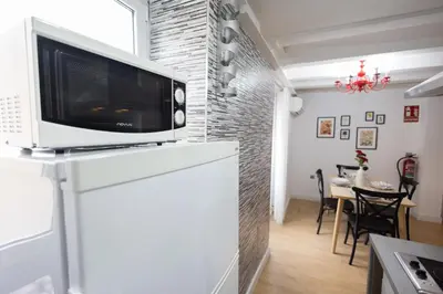 a microwave on top of a white cabinet in a kitchen at FLORIT FLATS - The Soho in Ruzafa in Valencia