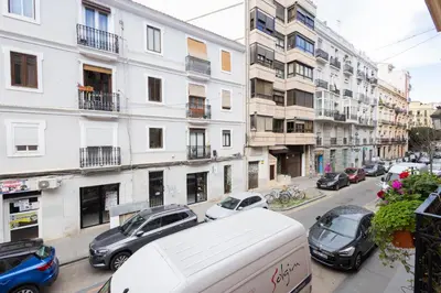 a city street with cars parked in front of buildings at FLORIT FLATS - The Soho in Ruzafa in Valencia