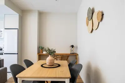 a dining room with a wooden table and chairs at FLORIT FLATS - Valencia Port Rooms I in Valencia