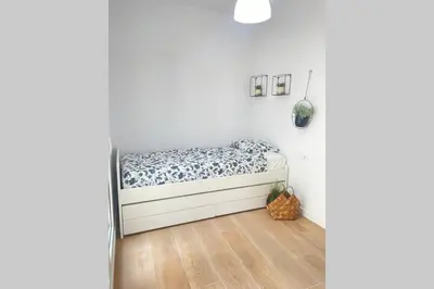 a bedroom with a bed in a white room at UIM Mediterraneo CASA Plomo Wifi in Puerto de Sagunto