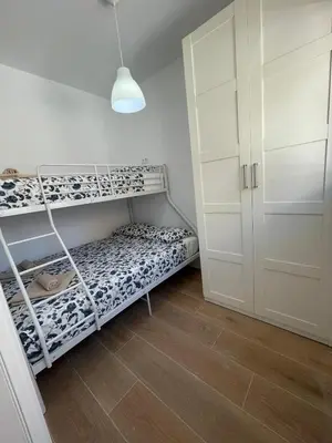a small room with a bunk bed and a closet at UIM Mediterraneo CASA Plomo Wifi in Puerto de Sagunto
