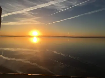 a sunset over a body of water with the sun at APPARTEMENT VUE MER 40 METRES DE LA PLAGE in Cullera