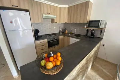 a kitchen with a bowl of fruit on a counter at APPARTEMENT VUE MER 40 METRES DE LA PLAGE in Cullera