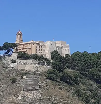 a building on top of a hill with trees at APPARTEMENT VUE MER 40 METRES DE LA PLAGE in Cullera
