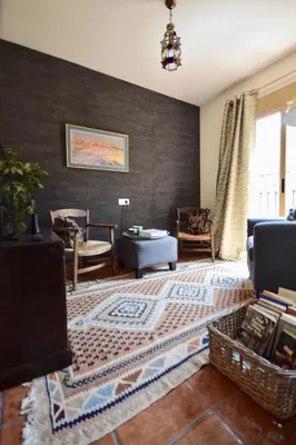 a living room with a couch and a table at Casa El Cielo, in the heart of Old Town in Chulilla