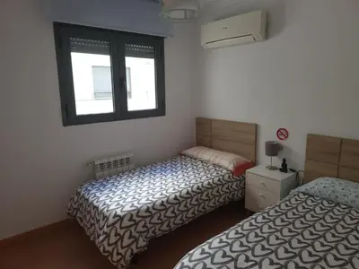 a bedroom with two beds and a window at BioHomeValencia in Valencia