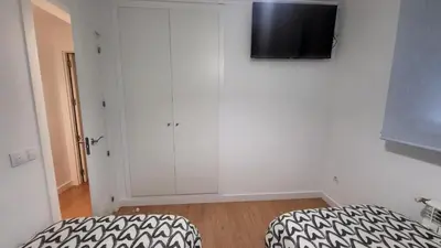 a bedroom with a bed and a tv on a wall at BioHomeValencia in Valencia