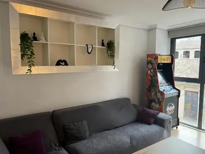 a living room with a couch and a video game at BioHomeValencia in Valencia
