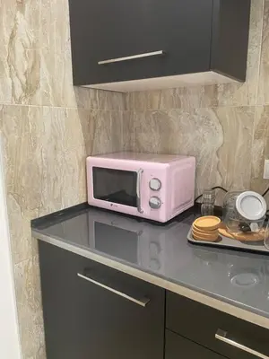 a bathroom with a washing machine and a sink at Haus LIDZBARSKI in Burriana