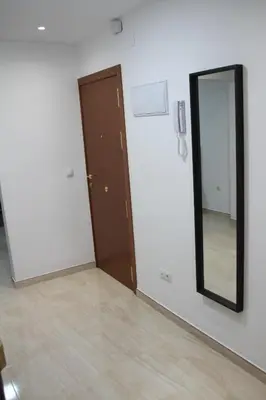 a living room with a chair and a bed at Haus LIDZBARSKI in Burriana