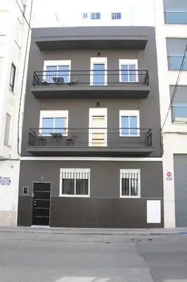 an apartment building with a balcony on the side of it at Haus LIDZBARSKI in Burriana