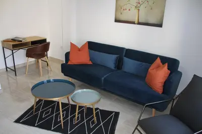a yellow couch in a living room with a table at Haus LIDZBARSKI in Burriana