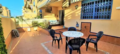 a patio with a table and chairs on a balcony at Apartamento Peonia 1 in Canet de Berenguer