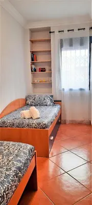 a bedroom with two beds and a window at Apartamento Peonia 1 in Canet de Berenguer