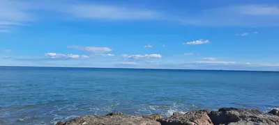 a view of the ocean with rocks in the water at Apartamento Peonia 1 in Canet de Berenguer