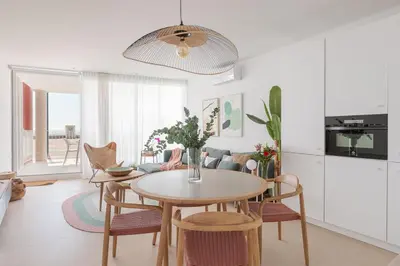 a kitchen and dining room with a table and chairs at Marsalada - Ground floor front line beach apartment in Playa de Mar