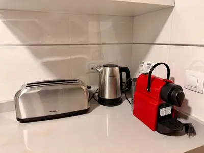 a kitchen counter with a toaster and a toaster gmaxwell gmaxwell gmaxwell at M & B Beach Apartment in Valencia