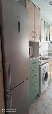 a kitchen with a refrigerator and a washer and dryer at Saint Germain 2C in Cullera